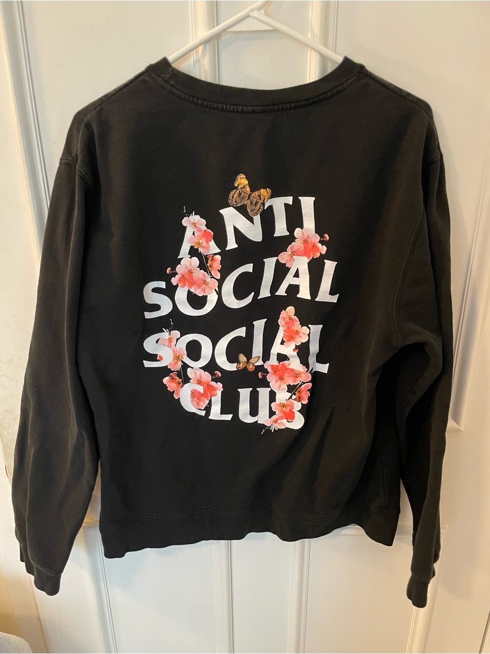 Anti Social Social Club Black Sweatshirt with Pink Floral and Butterfly Graphic
